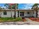 Close-up of a single-story home showcasing the brick entryway, front window, and address at 2001 Pinellas Point S Dr, St Petersburg, FL 33712