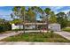 Lovely home with well-maintained lawn, mature trees, and inviting front entrance at 2001 Pinellas Point S Dr, St Petersburg, FL 33712