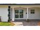 Welcoming covered front porch with brick facade and potted plants adding charm to the entrance at 2001 Pinellas Point S Dr, St Petersburg, FL 33712