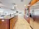 A well-equipped kitchen features an island, stainless steel appliances, granite countertops, and wooden cabinets at 2001 Pinellas Point S Dr, St Petersburg, FL 33712