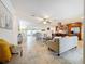 Spacious living room with tile floors, neutral décor, and open layout connecting to the kitchen and dining area at 2001 Pinellas Point S Dr, St Petersburg, FL 33712