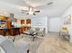 Open living area with tile flooring, comfortable furniture, and a stylish kitchen featuring a stainless steel range hood at 2001 Pinellas Point S Dr, St Petersburg, FL 33712