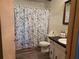 Cozy bathroom featuring a sink vanity with black countertop and a shower with a patterned curtain at 2071 Australia W Way # 59, Clearwater, FL 33763