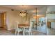 Charming dining room with a crystal chandelier and a mirrored wall creating an inviting atmosphere at 2071 Australia W Way # 59, Clearwater, FL 33763