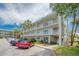 Exterior view of building with parked cars and surrounding landscaping at 2071 Australia W Way # 59, Clearwater, FL 33763