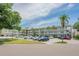 Wide exterior shot of condo building with palm trees and parked vehicles at 2071 Australia W Way # 59, Clearwater, FL 33763
