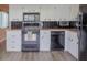 Functional kitchen featuring white cabinets and modern black appliances for a clean, timeless look at 2071 Australia W Way # 59, Clearwater, FL 33763