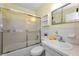 Cozy bathroom with tub and shower, plus tiled walls, vanity, and storage at 2460 Persian Dr # 54, Clearwater, FL 33763