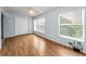 Well-lit bedroom featuring hardwood floors, large windows, and a spacious closet at 2460 Persian Dr # 54, Clearwater, FL 33763