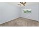 Neutral bedroom with a ceiling fan, window with a view, and plush carpeting at 2460 Persian Dr # 54, Clearwater, FL 33763