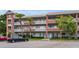 Condo exterior with balconies, brick accents, and convenient parking at 2460 Persian Dr # 54, Clearwater, FL 33763