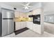 Compact kitchen features stainless steel refrigerator and black oven at 2460 Persian Dr # 54, Clearwater, FL 33763