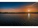 Scenic lake view with a vibrant sunset, reflecting the orange and yellow hues across the calm water at 2460 Persian Dr # 54, Clearwater, FL 33763
