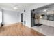 Open living area with hardwood floors flowing into a well-equipped kitchen at 2460 Persian Dr # 54, Clearwater, FL 33763