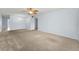 Open living space with carpet, ceiling fan, and bright chandelier at 2460 Persian Dr # 54, Clearwater, FL 33763