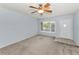 Carpeted living room with ceiling fan and ample natural light at 2460 Persian Dr # 54, Clearwater, FL 33763