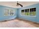 Bright bedroom featuring two large windows with exterior views and a ceiling fan at 2493 6Th Sw Ave, Largo, FL 33770