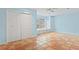 Bright blue bedroom featuring terracotta tile floors, a ceiling fan, and natural light at 2493 6Th Sw Ave, Largo, FL 33770