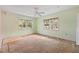 Light green bedroom featuring two windows providing ample natural light and a ceiling fan at 2493 6Th Sw Ave, Largo, FL 33770