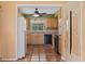 The kitchen features wood cabinets, terracotta tile flooring, black appliances, and natural light at 2493 6Th Sw Ave, Largo, FL 33770