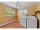 Laundry room featuring a washer, a dryer, a ceiling fan, and natural light at 2493 6Th Sw Ave, Largo, FL 33770