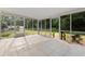 Screened patio with white tile floors and views of the backyard and landscaping at 2493 6Th Sw Ave, Largo, FL 33770