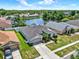 Aerial view of a charming property featuring lush landscaping, a well-maintained lawn, and a private driveway at 25330 Conestoga Dr, Land O Lakes, FL 34639