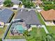 Aerial view of a single-Gathering home featuring a screened-in pool, fenced yard, and lush landscaping at 25330 Conestoga Dr, Land O Lakes, FL 34639
