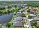 Aerial view of a neighborhood featuring mature trees and some lake views at 25330 Conestoga Dr, Land O Lakes, FL 34639