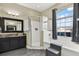 Bright bathroom featuring a soaking tub with a window view and a glass enclosed shower with a modern vanity at 25330 Conestoga Dr, Land O Lakes, FL 34639