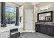 Bathroom featuring modern fixtures, a soaking tub, and large window with natural light at 25330 Conestoga Dr, Land O Lakes, FL 34639