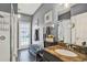 Bathroom with a glass enclosed shower, granite counters, modern decor, and an outdoor exit at 25330 Conestoga Dr, Land O Lakes, FL 34639