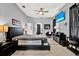 Comfortable bedroom features large bed, flatscreen television, and stylish decor at 25330 Conestoga Dr, Land O Lakes, FL 34639