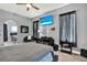 Bright bedroom featuring large bed, a television, and natural lighting at 25330 Conestoga Dr, Land O Lakes, FL 34639