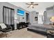 Spacious bedroom featuring a ceiling fan, large television, and views of the home at 25330 Conestoga Dr, Land O Lakes, FL 34639