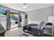 Bedroom featuring natural light, modern decor, a ceiling fan, and a view from the window at 25330 Conestoga Dr, Land O Lakes, FL 34639