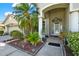 The front door is framed by columns and surrounded by lush landscaping at 25330 Conestoga Dr, Land O Lakes, FL 34639