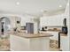Spacious kitchen featuring a breakfast bar, granite countertops, stainless steel appliances, and ample cabinetry at 25330 Conestoga Dr, Land O Lakes, FL 34639