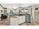 Kitchen with breakfast bar opens to the living room with views of the pool at 25330 Conestoga Dr, Land O Lakes, FL 34639