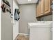Functional laundry room with overhead cabinets and a modern washer and dryer set for convenience at 25330 Conestoga Dr, Land O Lakes, FL 34639