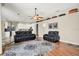 Spacious living room with hardwood floors, comfortable seating, and an open floor plan at 25330 Conestoga Dr, Land O Lakes, FL 34639