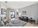 Cozy living room with gray walls, large rug, and a glimpse of the outdoor pool area at 25330 Conestoga Dr, Land O Lakes, FL 34639
