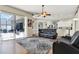 Open concept living area with tile flooring, ceiling fan, and sliding glass door to outdoor living space at 25330 Conestoga Dr, Land O Lakes, FL 34639