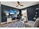 Home office featuring a ceiling fan, modern decor, and a TV for relaxation while working from home at 25330 Conestoga Dr, Land O Lakes, FL 34639