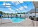 Relaxing screened-in pool area with lounge chairs, outdoor dining, and a beautiful pool at 25330 Conestoga Dr, Land O Lakes, FL 34639