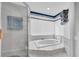 Bright bathroom featuring a glass shower, a garden tub, and a privacy window at 3177 Montrose Pl, Palm Harbor, FL 34684