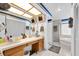 Bathroom featuring double sinks, tile floors, a shower, and a soaking tub at 3177 Montrose Pl, Palm Harbor, FL 34684