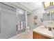 Simple bathroom showcasing a walk-in shower, single sink, and neutral tile at 3177 Montrose Pl, Palm Harbor, FL 34684