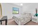 Bright bedroom with white walls and a ceiling fan above a queen-sized bed at 3177 Montrose Pl, Palm Harbor, FL 34684