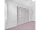 Bedroom showing a closet with white sliding doors on a neutral carpeted floor at 3177 Montrose Pl, Palm Harbor, FL 34684